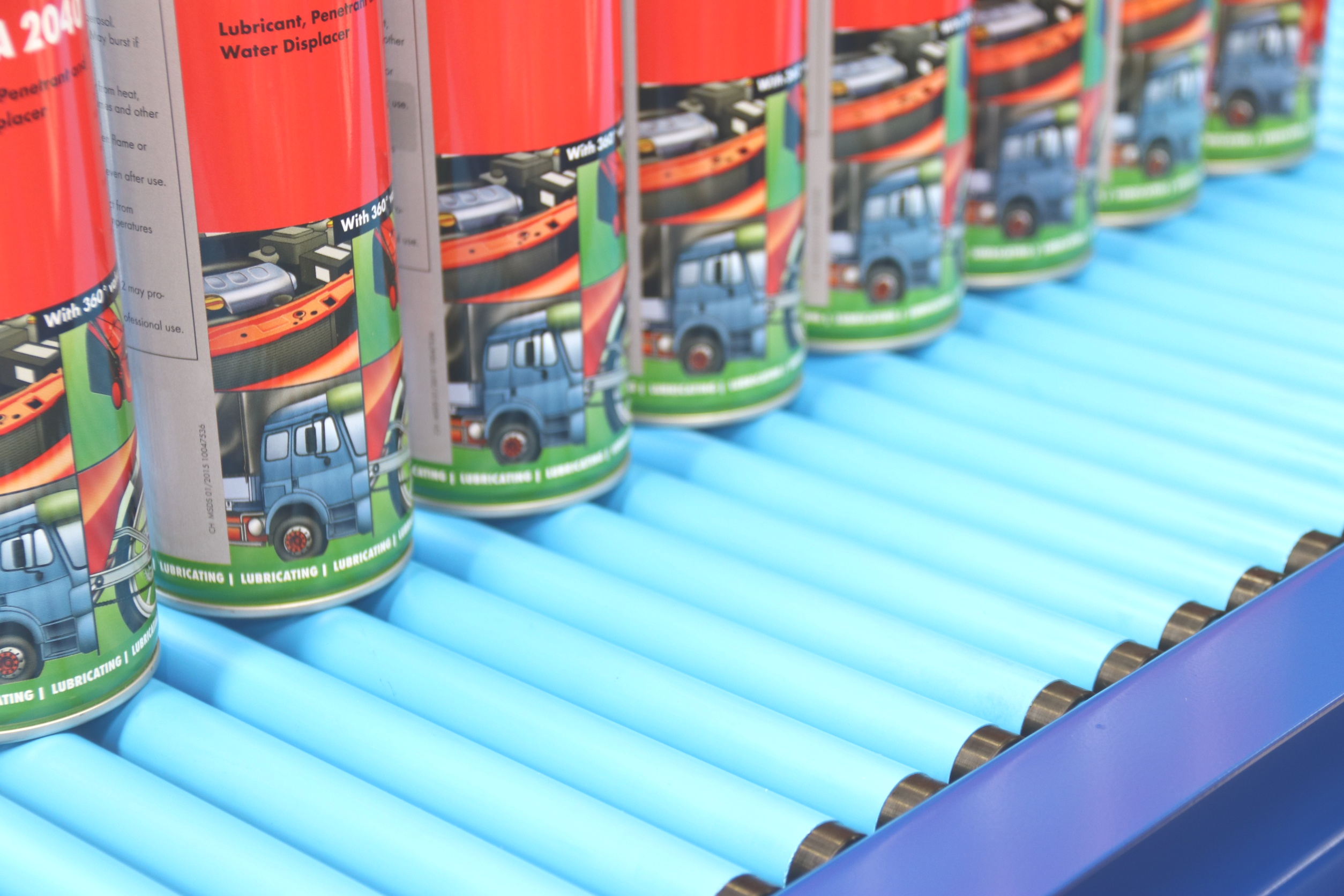 Light duty gravity conveyor transporting small packages in a warehouse, demonstrating efficient material handling without powered rollers.